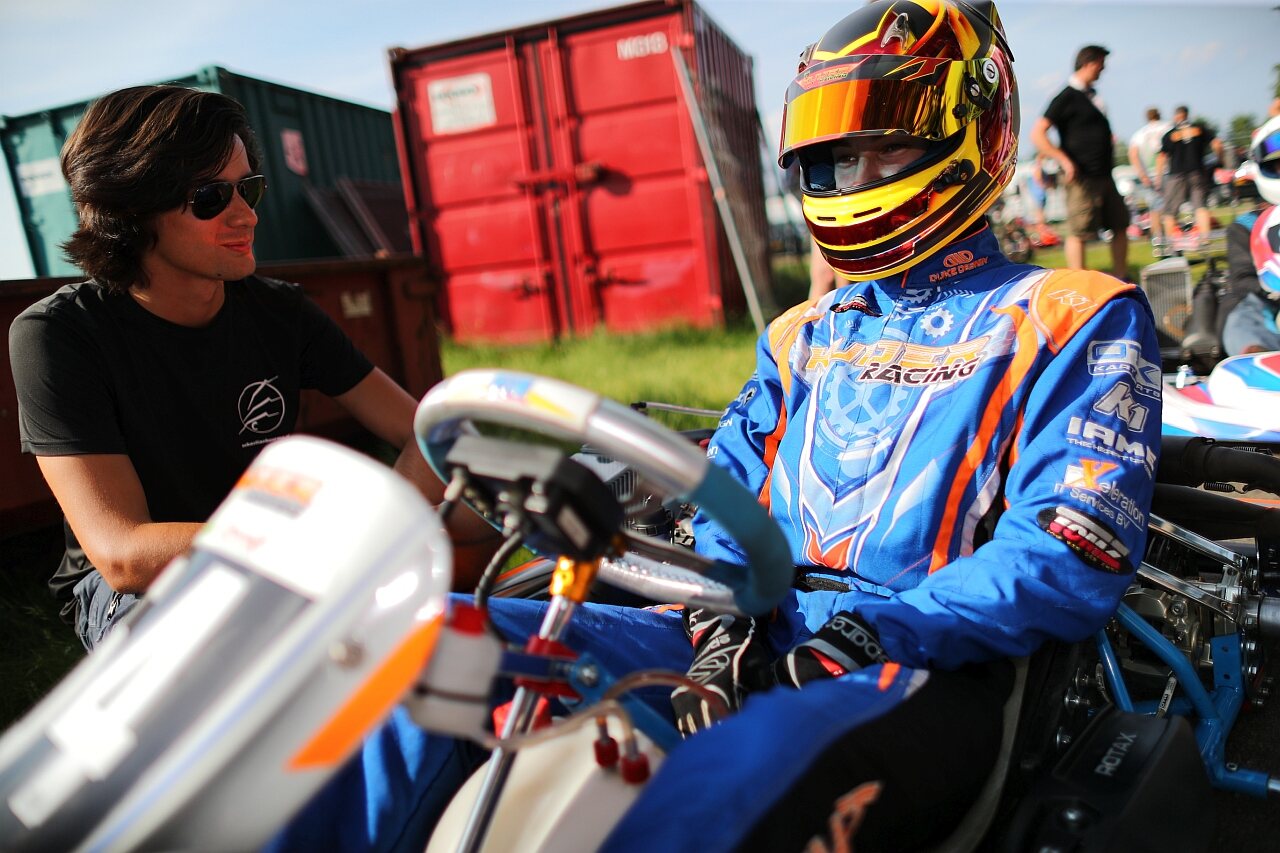 Sebastian Buurma talking with a young karting driver